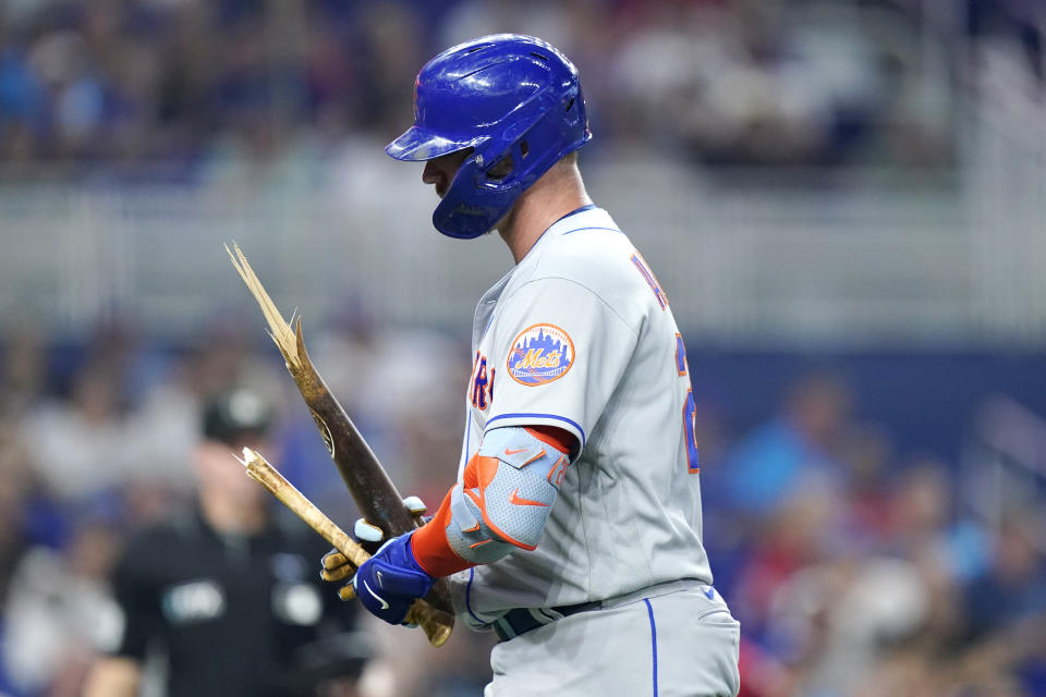 New York Mets' Pete Alonso walks to the dugout after breaking his bat after he was out on a pop fly during the fifth inning of a baseball game against the Miami Marlins, Saturday, June 25, 2022, in Miami. (AP Photo/Lynne Sladky)