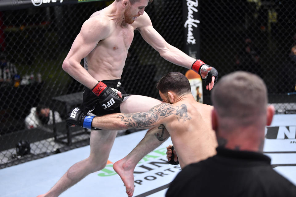 LAS VEGAS, NEVADA - FEBRUARY 06: Cory Sandhagen lands a flying knee to knock out Frankie Edgar in their bantamweight fight during the UFC Fight Night event at UFC APEX on February 06, 2021 in Las Vegas, Nevada. (Photo by Chris Unger/Zuffa LLC)