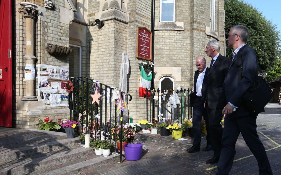 Residents gathered to speak with Sir Martin Moore-Bick (centre) at Notting Hill Methodist Church in Notting Hill, London - Credit:  Jonathan Brady/PA