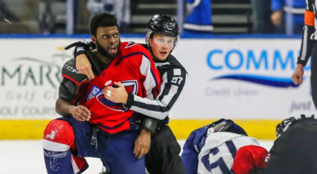 Jordan Subban is held by the referee after he was allegedly taunted by Jacob Panetta in a minor league hockey game. (Photo: AP/Gary McCullough)