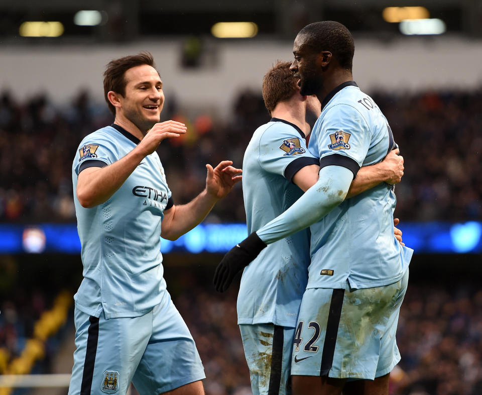 Manchester City's Yaya Toure (right) celebrates scoring his sides third goal of the game with team-mates Frank Lampard (left) and James Milner during the Barclays Premier League match at the Etihad Stadium, Manchester.