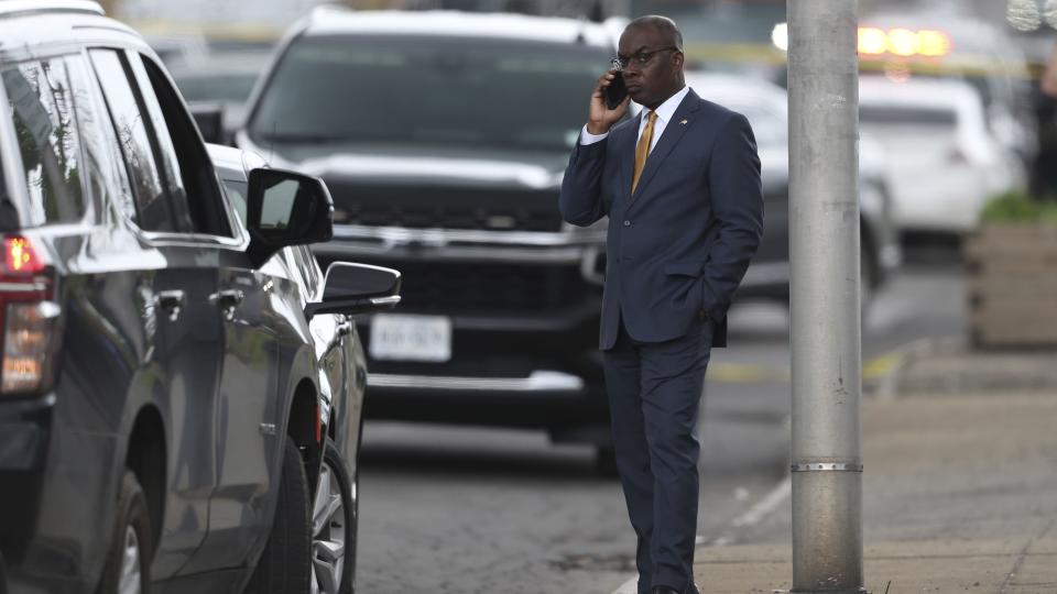 Buffalo mayor Byron Brown takes a call after a shooting at a supermarket on Saturday, May 14, 2022, in Buffalo, N.Y. Officials said the gunman entered the supermarket with a rifle and opened fire. Investigators believe the man may have been livestreaming the shooting and were looking into whether he had posted a manifesto online.