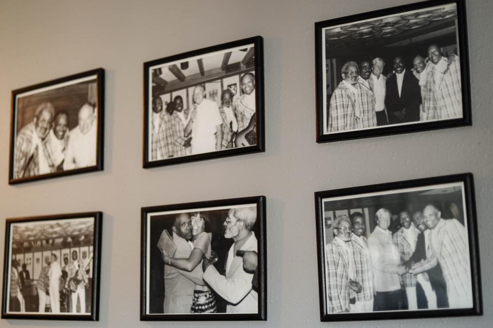 Photos of jazz legend Julius Brooks and his friends hang on a wall in his home at Corinthian Gardens in Des Moines on Nov. 7. Brooks played on the road with Ray Charles, James Brown, Little Richard, the Four Tops, Louis Jordan and the Ink Spots.