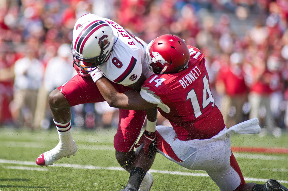 Oct 12, 2013; Fayetteville, AR, USA; South Carolina Gamecock wide receiver Shamier Jeffery (8) is brought down by Arkansas Razorbacks safety Eric Bennett (14) during a game at Donald W. Reynolds Razorback Stadium. South Carolina defeated Arkansas 52-7. Mandatory Credit: Beth Hall-USA TODAY Sports