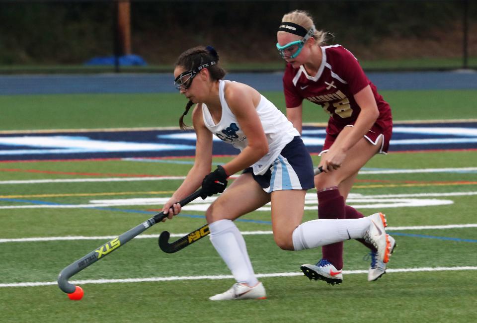 From left, John Jay's Ashley Tricarico controls a pass in front of Arlington's Samantha Van Voorhis during an Oct. 19, 2019 field hockey game.