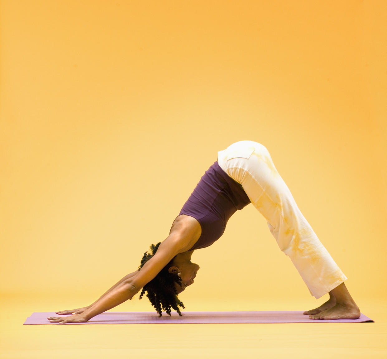 If you only do one yoga pose after a long day at work, make it a downward-facing dog, a holistic pose that stretches and strengthens many parts of the body. To come into the pose, move into an inverted "V' shape. With hands outstretched in front and you, lift the hips and ground the feet (at about hips-width apart) into the floor. Ground all the fingers into the floor and point them forward, bring your attention to the breath as you enjoy the stretch for 30-60 seconds.  "It helps you lengthen and strengthen muscles in the body," says Vidya Bielkus, certified yoga teacher and co-founder of Health Yoga Life. "It reduces tension in the shoulders, relaxes the neck, and lets a little more blood flow get to the brain. You're also able to really stretch the legs, so if you're sitting all day, the legs are getting inactive."  The pose is also great for stretching out the wrists and hands, which may become sore or tired from hours of typing.