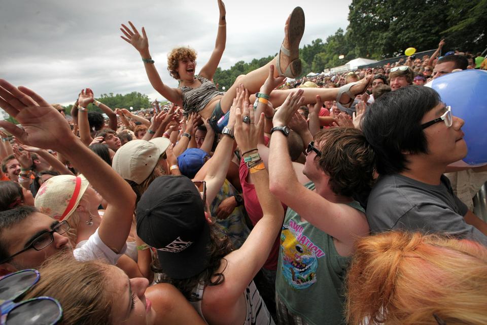 A fan body surfs in the crowd as AWOLNation performs in The Woodlands of Dover on The Lawn stage at Firefly Music Festival on July 22, 2012 during the fesitval's first year. Fans have compared the rising Oceans Calling Festival to a younger Firefly.