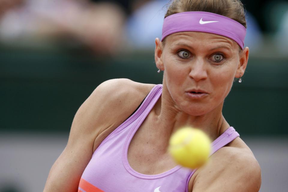 Lucie Safarova of the Czech Republic returns the ball to Garbine Muguruza of Spain during their women's quarter-final match during the French Open tennis tournament at the Roland Garros stadium in Paris