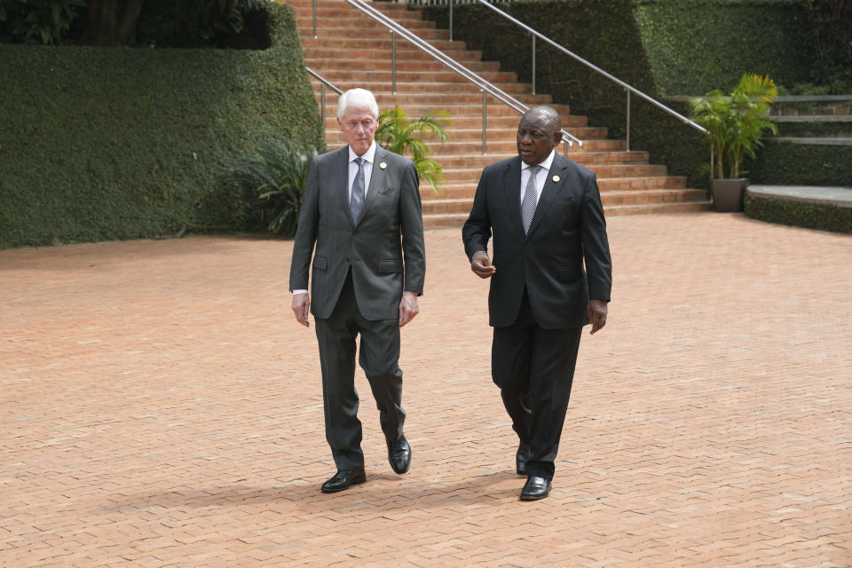 Former US President Bill Clinton, left, and South Africa's President Cyril Ramaphosa arrive to lay a wreath at the Kigali Genocide Memorial, in Kigali, Rwanda, Sunday, April 7, 2024. Rwandans are commemorating 30 years since the genocide in which an estimated 800,000 people were killed by government-backed extremists, shattering this small east African country that continues to grapple with the horrific legacy of the massacres. (AP Photo/Brian Inganga)