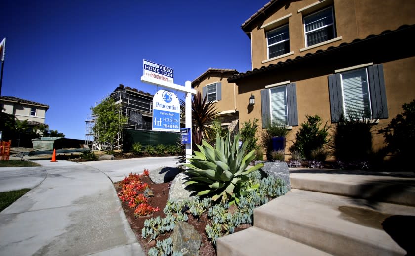 An existing occupied home sits for sale next to new homes under construction Wednesday April 17, 2013 in Carlsbad, Calif. The research firm Dataquick reported Wednesday that home sales in Southern California rose three percent over one year ago, the highest March sales tally since 2007. (AP Photo/Lenny Ignelzi)