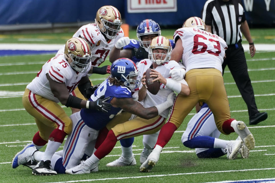 San Francisco 49ers quarterback Nick Mullens, center, is sacked by New York Giants Leonard Williams (99) during the first half of an NFL football game, Sunday, Sept. 27, 2020, in East Rutherford, N.J. (AP Photo/Corey Sipkin)