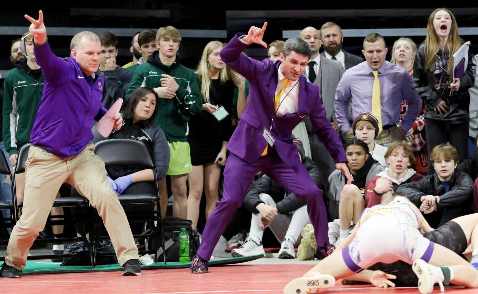 Watertown High School wrestling coaches Aaron Althoff (left), Chas Welch (center) and Scott Stone (right with yellow tie) look on after an Arrow wrestler picked up some points during the 2023 South Dakota State Wrestling Championships last week in Rapid City.