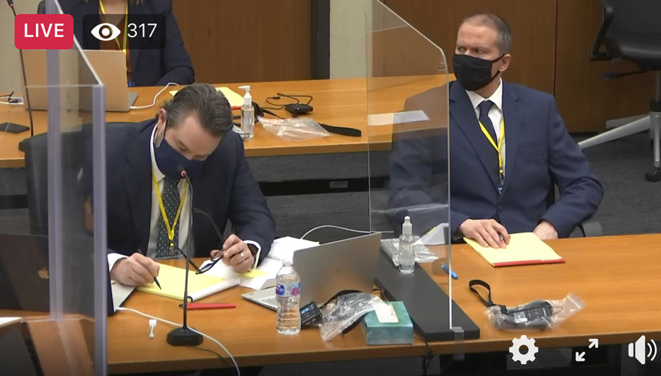 In this image taken from video, defense attorney Eric Nelson, left, and defendant, former Minneapolis police officer Derek Chauvin, right, listen as Hennepin County Judge Peter Cahill presides over a hearing before jury selection, Monday, March 8, 2021, in Chauvin's trial at the Hennepin County Courthouse in Minneapolis, Minn. Chauvin is accused in the May 2020 death of George Floyd. (Court TV/Pool via AP)