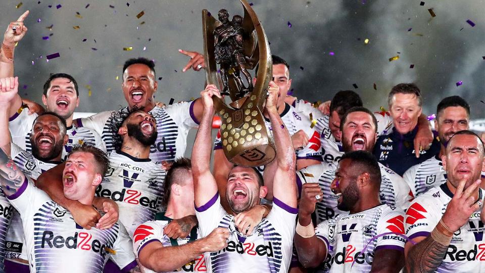 Cameron Smith and the Storm lift the NRL trophy.