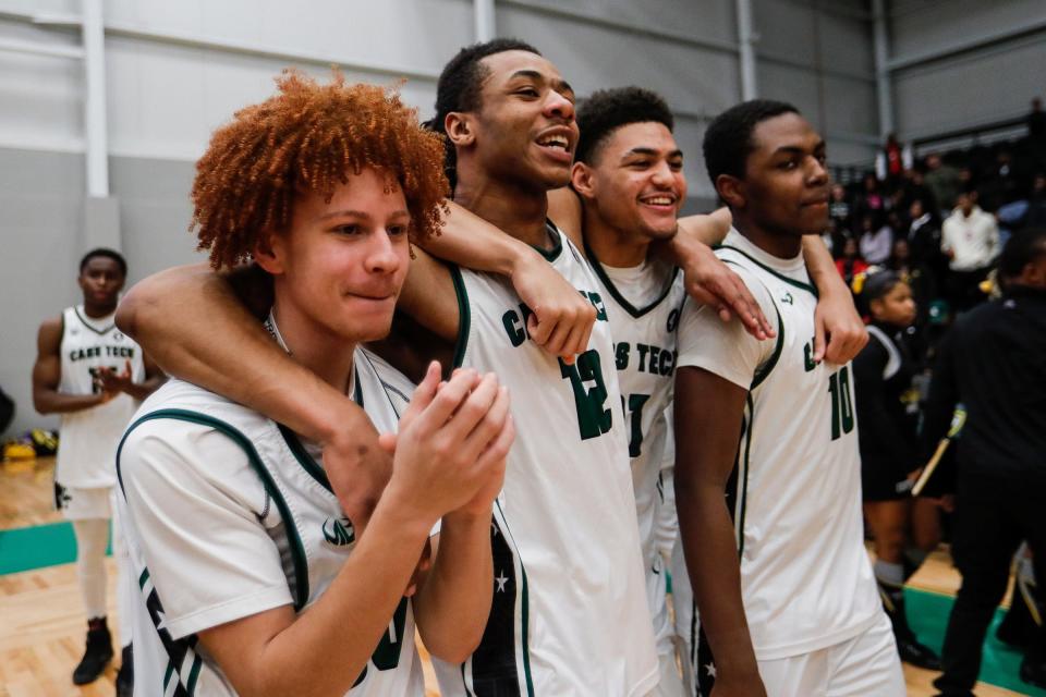 Cass Tech players celebrate 74-70 win over Detroit King in the PSL championship game at the Wayne State Fieldhouse in Detroit on Sunday, February 19, 2023.