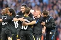 Wigan Athletic's Ben Watson (second right) is mobbed by team-mates and staff, after the final whistle