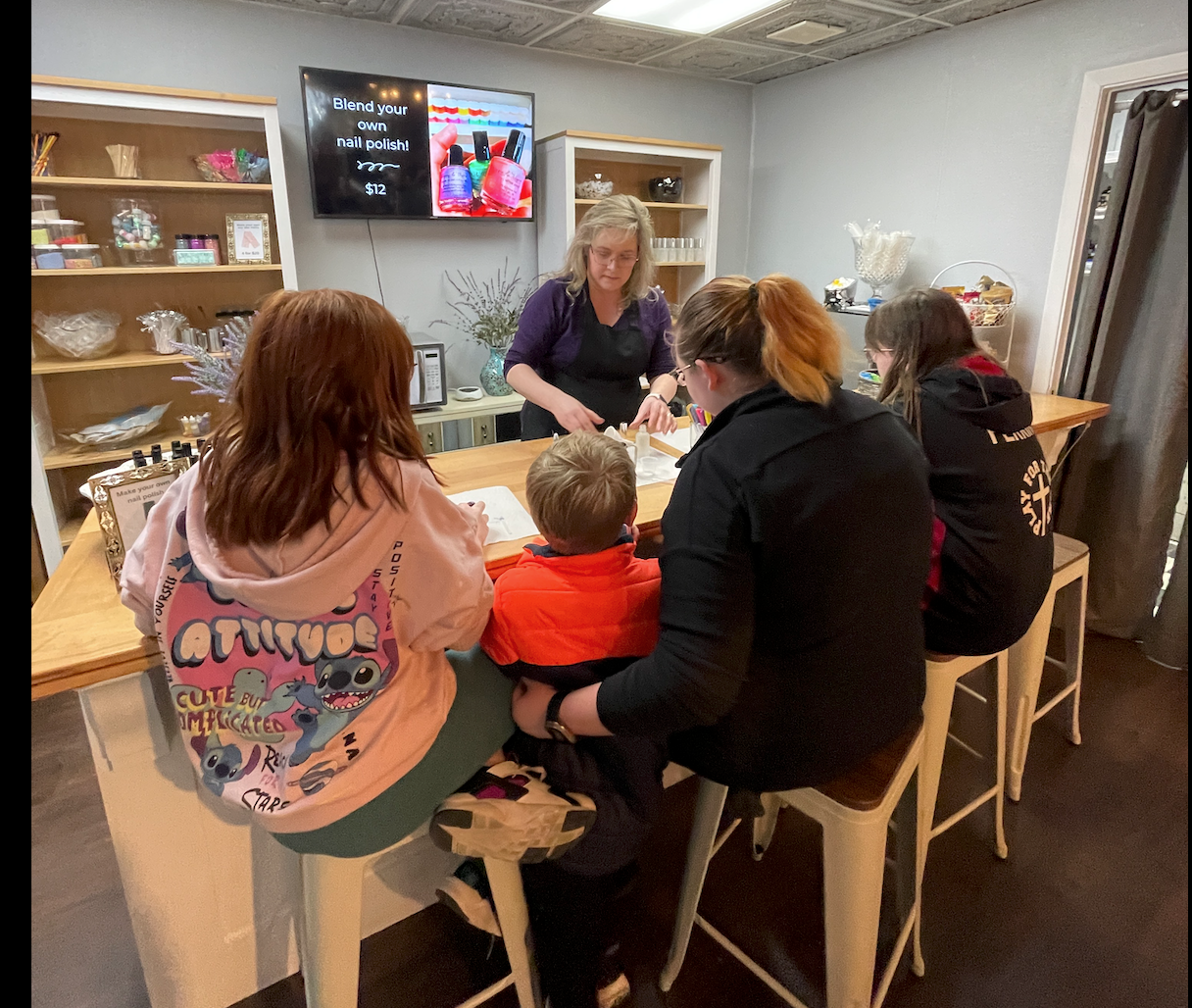 Downtown Menomonee Falls will have its inaugural Make & Take Shop Hop from 11 a.m. to 5 p.m. June 18 to 22.  Pictured, Owner Layla Obregon is working with DIY makers at her downtown Menomonee Falls business, Poppy &Thyme. In Poppy & Thyme's expanded space, people can come in to create personalized scented candles, wax melts, perfumes and nail polish.