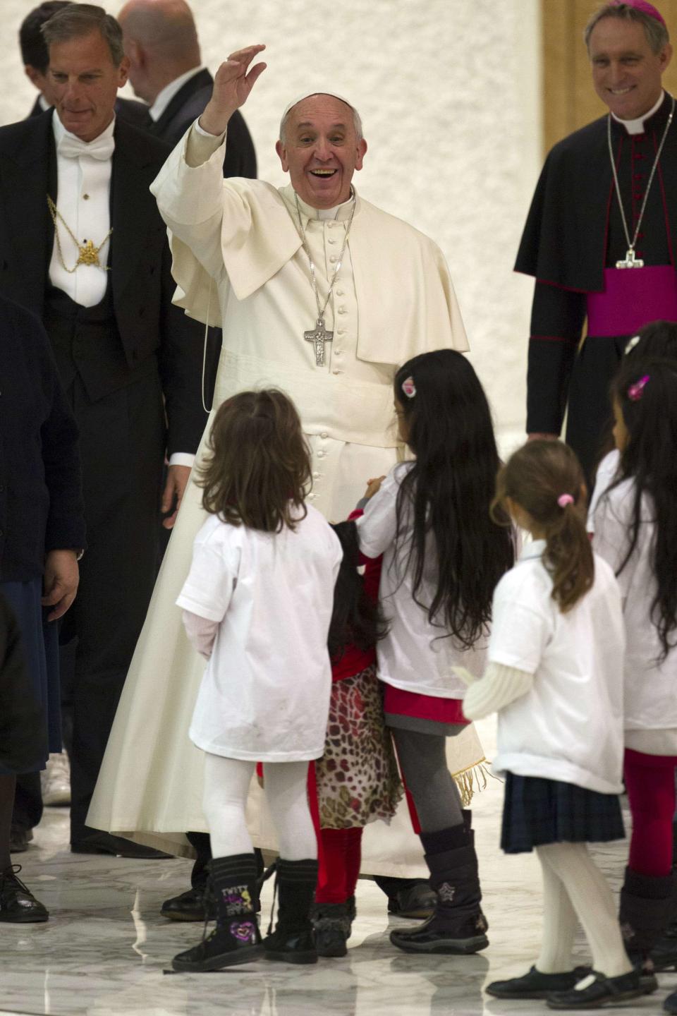 Pope Francis waves at the end of an audience with children assisted by volunteers of Santa Marta institute in the Vatican