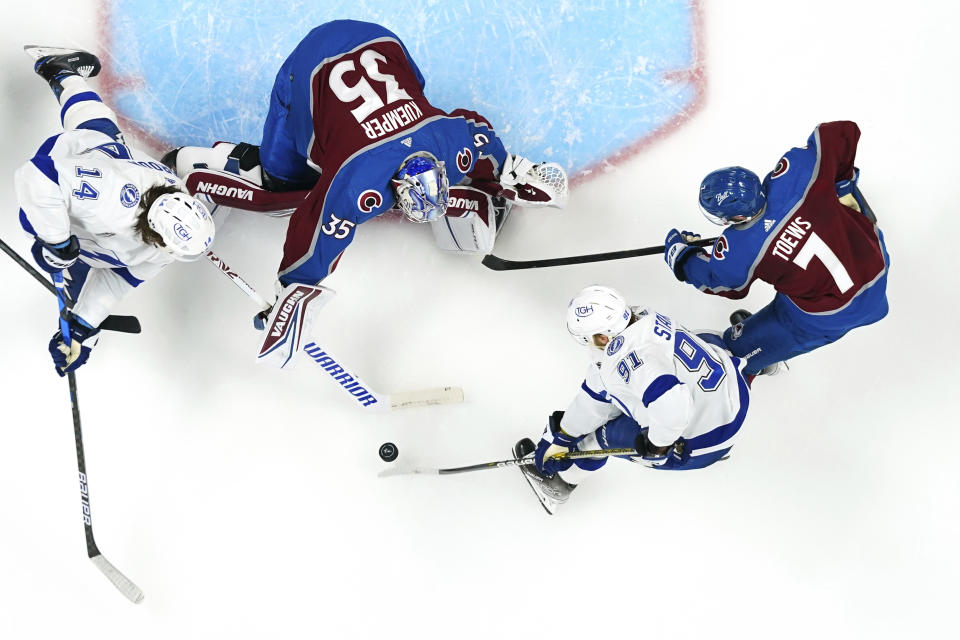 Colorado Avalanche goaltender Darcy Kuemper (35) blocks a shot by Tampa Bay Lightning center Steven Stamkos (91) during the overtime in Game 1 of the NHL hockey Stanley Cup Final on Wednesday, June 15, 2022, in Denver. (AP Photo/John Locher)