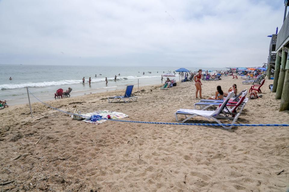 Ropes running parallel to the ocean previously blocked off part of the shore at the Atlantic Beach Casino at Misquamicut Beach. Police took them down on July 4 because they were inside the 10-foot zone above the seaweed line where the public is legally allowed.