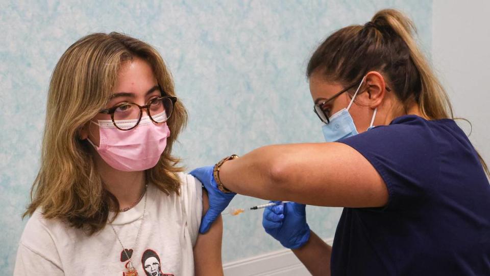 Gracey May, 14, gets her first dose of the Pfizer COVID-19 vaccine from Maranda Mendibles, a registered medical assistant at Bravo Pediatrics. Dr. René Bravo recently began holding weekly coronavirus vaccine clinics at his office in San Luis Obispo.