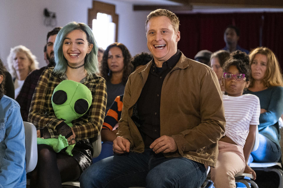 This image released by SYFY shows Taylor Blackwell, left, and Alan Tudyk in a scene from "Resident Alien." In the series, Tudyk's character was tasked with destroying all Earthlings, and he takes the life and identity of Dr. Harry Vanderspeigle to appear human, but awkwardly, as he pursues his mission. Instead, he begins to value his intended victims. (SYFY via AP)