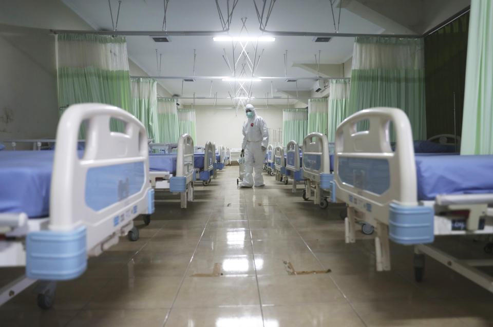 A medics inspects makeshift isolation rooms at Patriot Candrabhaga stadium prepared to become a quarantine facility for people showing symptoms of the COVID-19 amid the new coronavirus outbreak in Bekasi on the outskirts of Jakarta, Indonesia, Wednesday, Sept. 9, 2020. While Indonesia has recorded more deaths from the coronavirus than any other Southeast Asian country, it also has seen by far the most fatalities among medical workers in the region, leading to concerns about the long-term impact on the nation's fragile healthcare system. (AP Photo/Achmad Ibrahim)