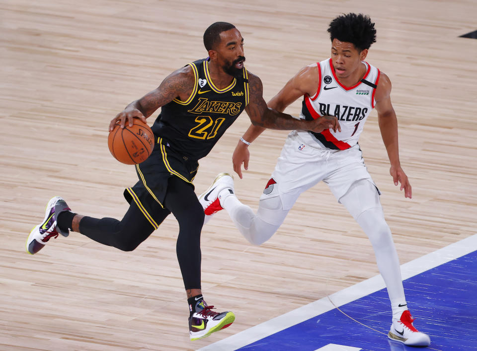 Los Angeles Lakers' JR Smith (21) moves the ball against Portland Trail Blazers' Anfernee Simons (1) during the second quarter of Game 4 of an NBA basketball first-round playoff series, Monday, Aug. 24, 2020, in Lake Buena Vista, Fla. (Kevin C. Cox/Pool Photo via AP)