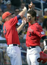 Stony Brook's Pat Cantwell, right, celebrates with teammates after hitting a solo home run against UCLA during the third inning of an NCAA College World Series baseball game in Omaha, Neb., Friday, June 15, 2012. (AP Photo/Ted Kirk)