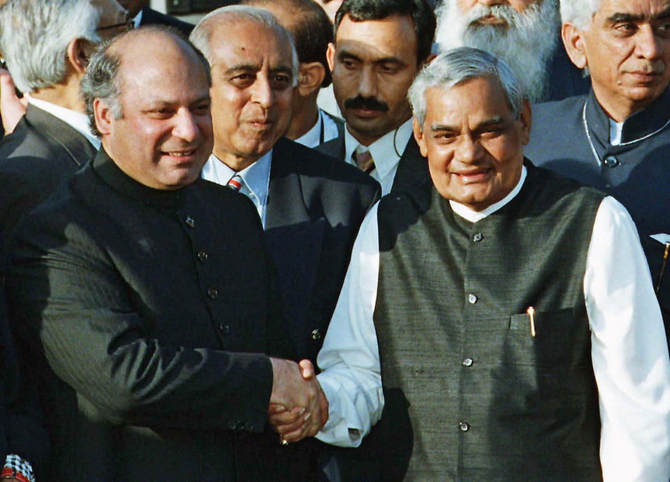 FILE- In this Feb. 20, 1999 file photo, Pakistani Prime Minister Nawaz Sharif, left, receives Indian Prime Minister Atal Bihari Vajpayee at the Wagah border near Lahore, Pakistan. Former prime minister Vajpayee, who pursued both nuclear weapons and peace talks with Pakistan, died Thursday, Aug. 16, 2018, at age 93. (AP Photo/B.K. Bangash, File)