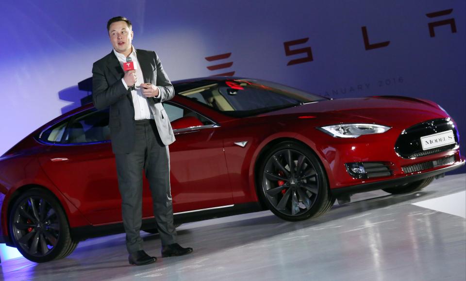 Tesla Motors CEO Elon Musk speaks to the media next to its Model S in Hong Kong on January 25, 2016.