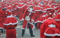 MICHENDORF, GERMANY - DECEMBER 09: Participants dressed as Santa Claus run in the 4th annual Michendorf Santa Run (Michendorfer Nikolauslauf) on December 9, 2012 in Michendorf, Germany. Over 800 people took part in this year's races that included children's and adults' races. (Photo by Sean Gallup/Getty Images)