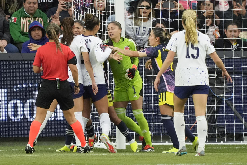 Players from the United States and Colombia get into a shoving match during the first half of a CONCACAF Gold Cup women's soccer tournament quarterfinal, Sunday, March 3, 2024, in Los Angeles. (AP Photo/Marcio Jose Sanchez)