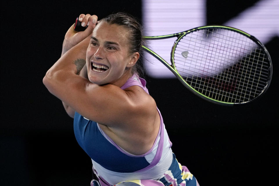 Aryna Sabalenka of Belarus plays a backhand return to Magda Linette of Poland during their semifinal match at the Australian Open tennis championship in Melbourne, Australia, Thursday, Jan. 26, 2023. (AP Photo/Aaron Favila)