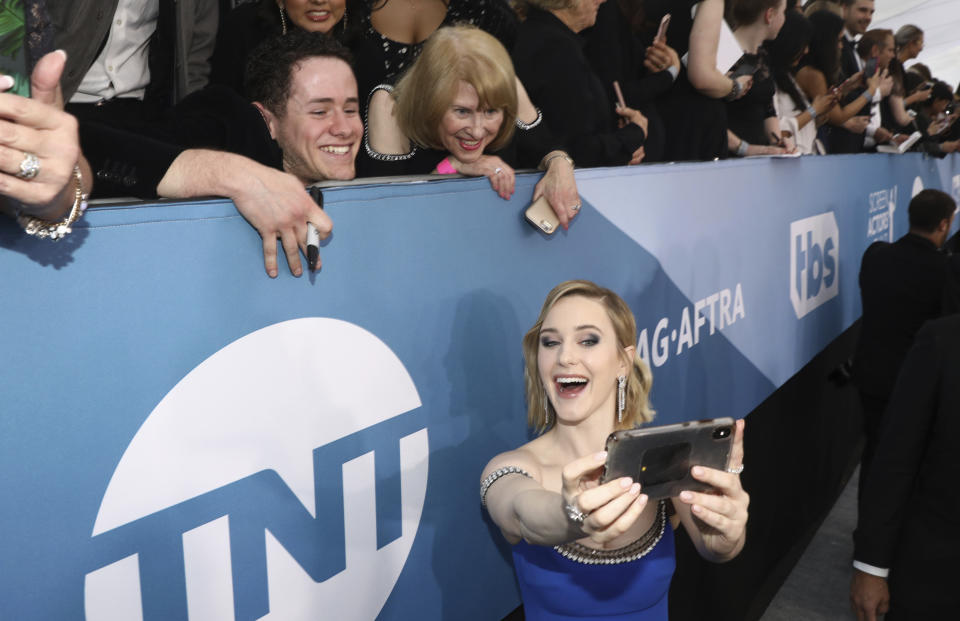 Rachel Brosnahan takes a selfie with fans as she arrives at the 26th annual Screen Actors Guild Awards at the Shrine Auditorium & Expo Hall on Sunday, Jan. 19, 2020, in Los Angeles. (Photo by Matt Sayles/Invision/AP)