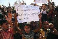 A boy holds a placard as hundreds of Rohingya refugees protest against their repatriation at the Unchiprang camp in Teknaf, Bangladesh November 15, 2018. REUTERS/Mohammad Ponir Hossain