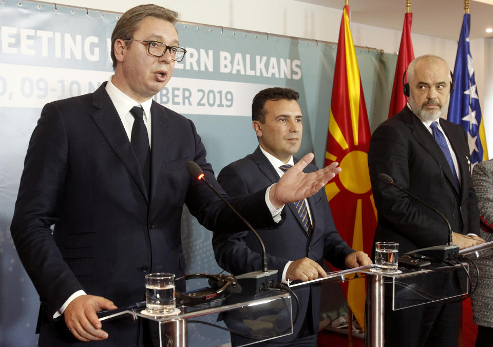 Serbia's President Aleksandar Vucic, left, talks i presence of North Macedonia's Prime Minister Zoran Zaev, center and Albania's Prime Minister Edi Rama, right, during a joint news conference, following the Western Balkan leaders' meeting in the southwestern town of Ohrid, North Macedonia, Sunday, Nov. 10, 2019. Western Balkan leaders say they are committed to work closely and to remove administrative barriers for free movement of goods and people between their countries. (AP Photo/Boris Grdanoski)