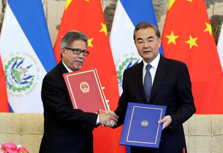 Chinese Foreign Minister Wang Yi (R) and El Salvador's Foreign Minister Carlos Castaneda attend a signing ceremony to establish diplomatic ties between the two countries, at the Diaoyutai State Guesthouse in Beijing, China August 21, 2018. REUTERS/Jason Lee