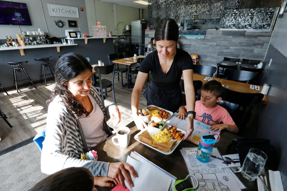 Victoria Camara serves breakfast to Marcy Cimoni and her twin boys, Henry and Theo, 5, at the newly opened What's Cookin on Acushnet Avenue in New Bedford.