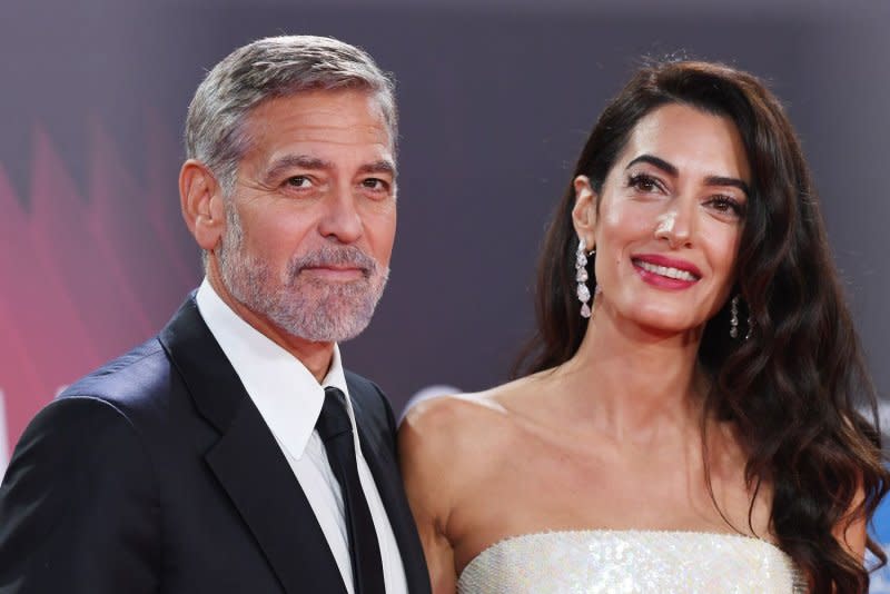 George Clooney (L), pictured with Amal Clooney, stars in the new action comedy "Wolfs." File Photo by Rune Hellestad/UPI