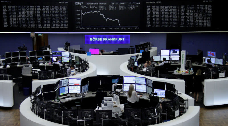 Traders work in front of the German share price index, DAX board, at the stock exchange in Frankfurt, Germany, July 21, 2017. REUTERS/Staff/Remote