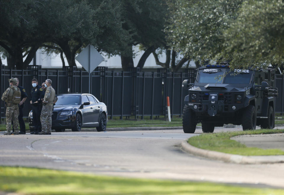 Law enforcement officials work on the scene of an officer-involved shooting at an apartment complex on Tuesday, Oct. 20, 2020, in Houston. Two Houston officers were shot before a SWAT team was dispatched to the scene, where the suspected shooter was arrested, authorities said. (Godofredo A. Vásquez / Houston Chronicle via AP)