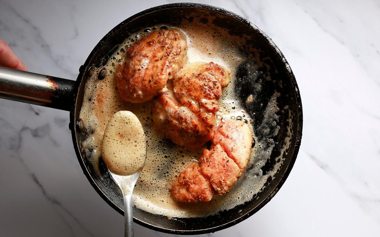 Veal sweetbreads being seared in a pan