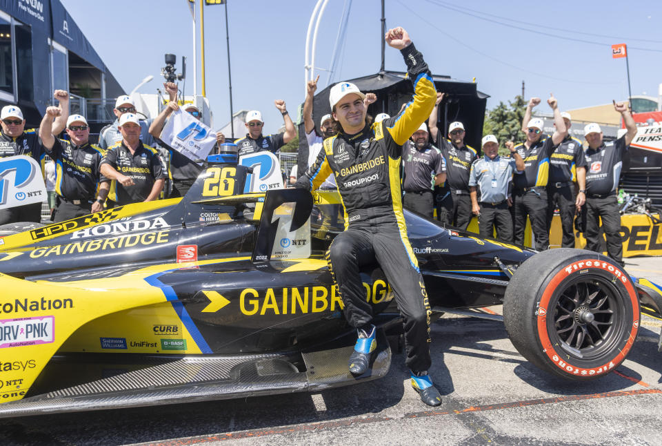 FILE -Colton Herta of the United States celebrates winning the pole position following qualifying at the 2022 IndyCar Toronto, in Toronto, Saturday, July 16, 2022. Colton Herta has signed a four-year contract extension with Andretti Autosport that ties him to the IndyCar team through 2027. The agreement announced Tuesday, Oct. 25, 2022, includes a concurrent contract extension with sponsor Gainbridge, which could signify the end of Herta’s Formula One ambitions and acknowledgement that Michael Andretti is not getting an F1 team. (Mark Blinch/The Canadian Press via AP, File)