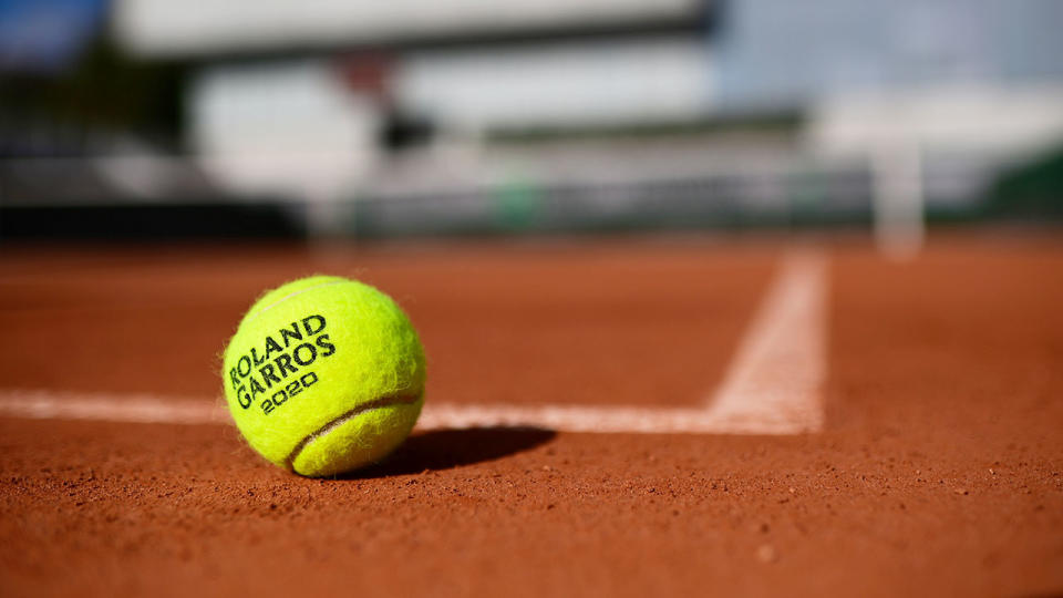 A solitary tennis ball can be seen here resting on the clay at Roland Garros.