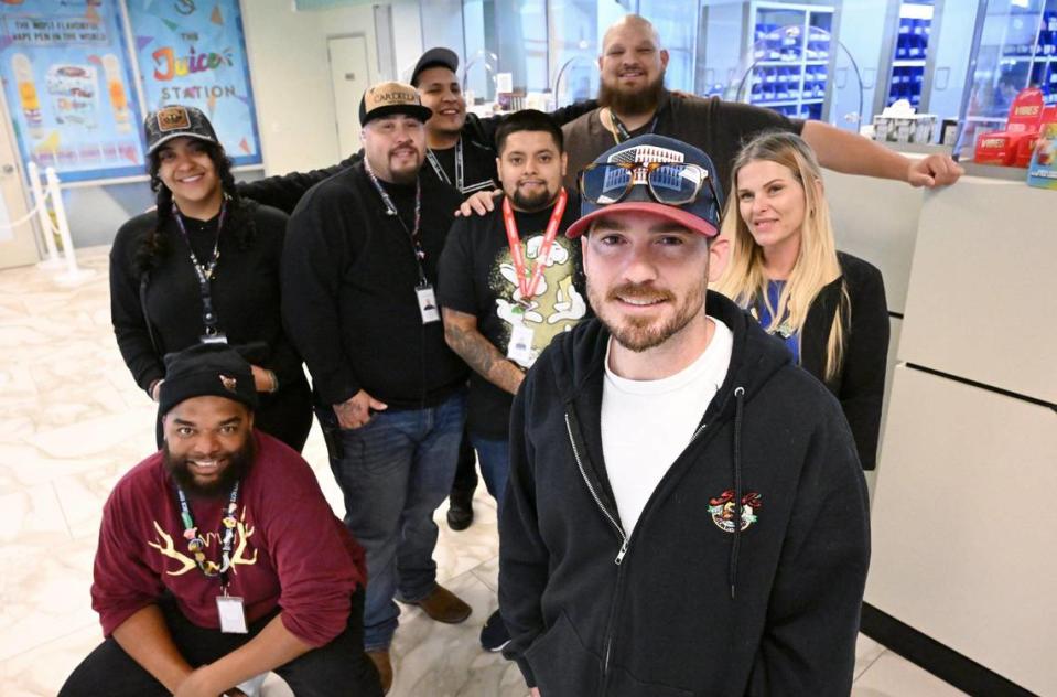 Josh Rogina, owner and operations manager, shown with his team behind him, has opened Fresno’s third and newest cannabis dispensary The Station, located in a former bank on Shaw Ave. across from Fashion Fair. Photographed Tuesday, Dec. 5, 2023 in Fresno.