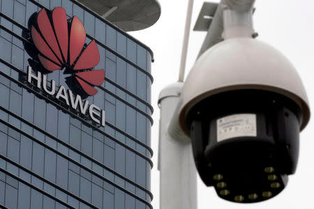 FILE PHOTO: A surveillance camera is seen in front of the Huawei logo outside its factory campus in Dongguan, Guangdong province, China, March 25, 2019. REUTERS/Tyrone Siu/File Photo