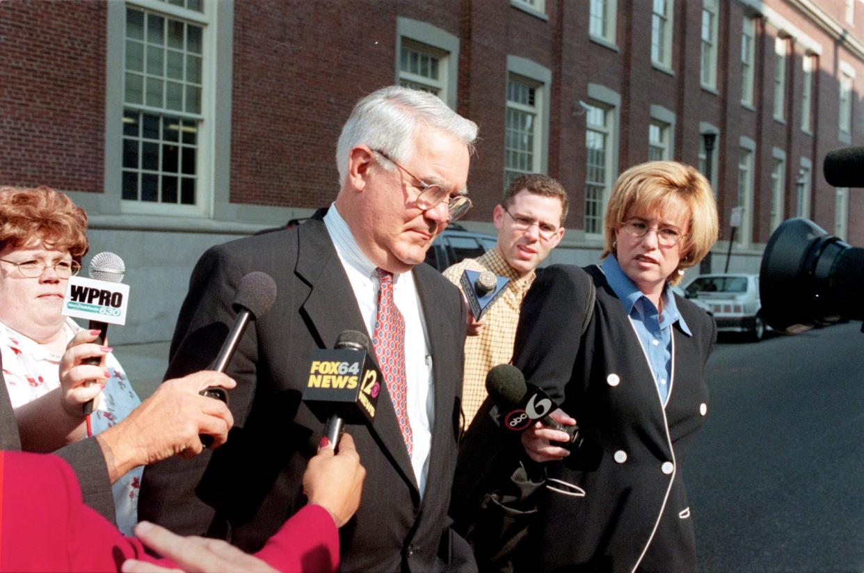 Lawyer John Scungio, center, tries to avoid the media after leaving federal court. He pleaded guilty to lying to FBI agents when he denied delivering a bribe to a top tax official on behalf of a client.