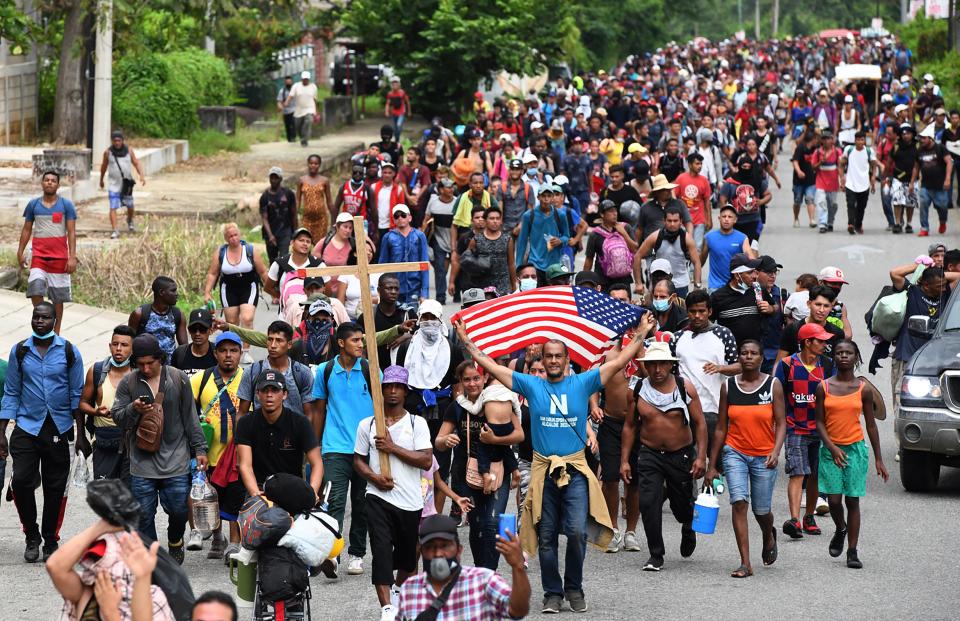Migrants heading in a caravan to the US, walk towards Mexico City to request asylum and refugee status in Huixtla, Chiapas State, Mexico, on October 25, 2021. (Photo by ISAAC GUZMAN / AFP) (Photo by ISAAC GUZMAN/AFP via Getty Images)