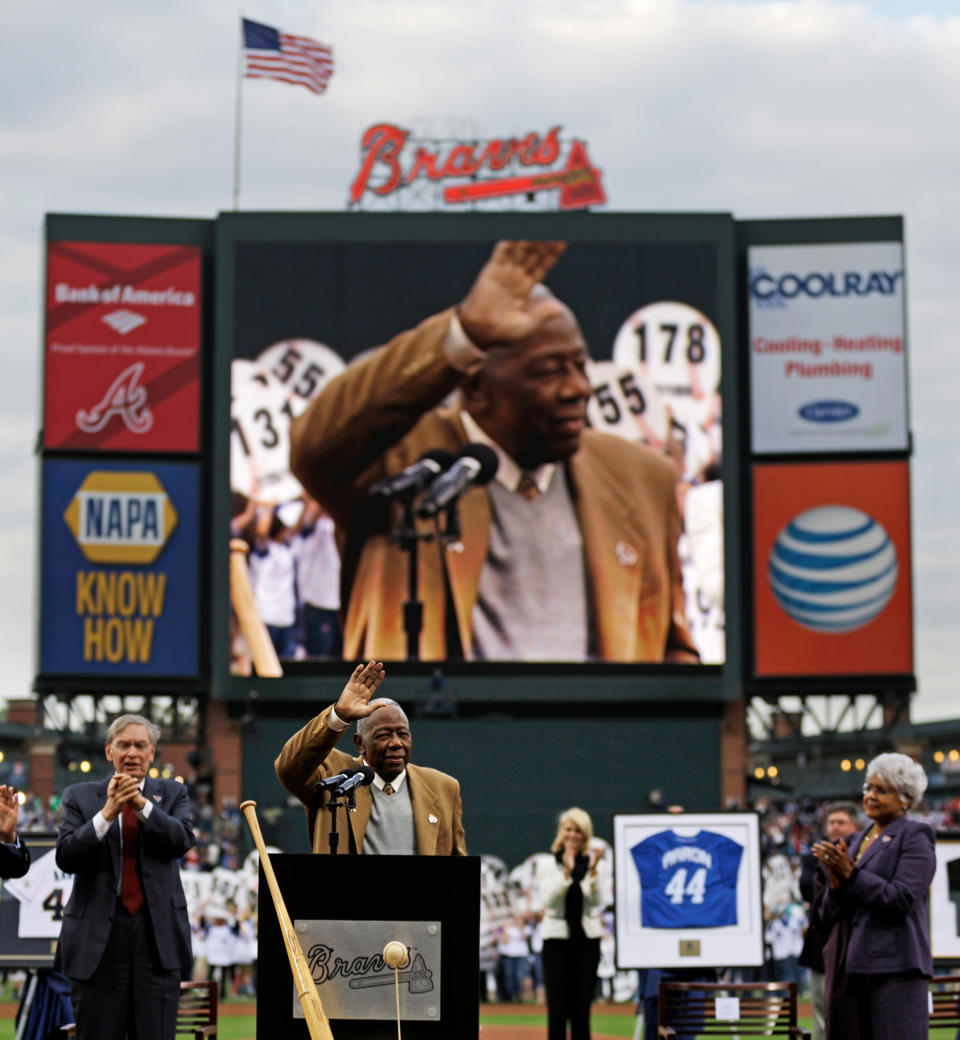 Hank Aaron waves to the crowd during a ceremony celebrating the 40th anniversary of his 715th home run before the start of a baseball game between the Atlanta Braves and the New York Mets, Tuesday, April 8, 2014, in Atlanta. (AP Photo/David Goldman)
